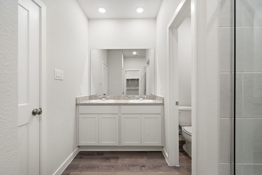 A bathroom with white cabinets. A bathroom with white cabinets.
