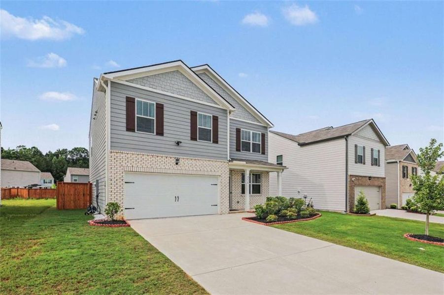 Front exterior of a new home in , Fairburn, GA, highlighting curb appeal (Image 1). Front exterior of a new home in , Fairburn, GA, highlighting curb appeal (Image 1).