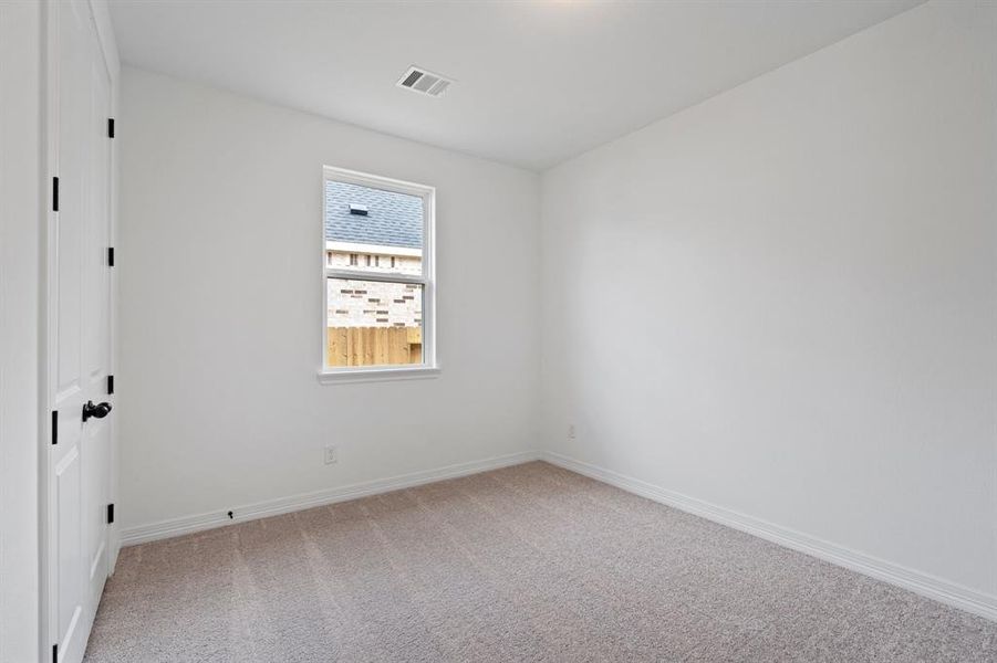 Your secondary bedroom features plush carpet, fresh paint, closet, and a large window that lets in plenty of natural lighting.