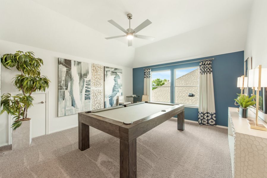 Game room with pool table, vaulted ceiling, ceiling fan, and blue accent wall with carpet flooring