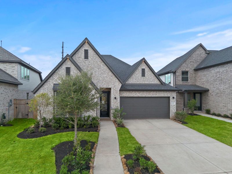 Front exterior of a new home in Sienna 45', 50', Missouri City, TX, highlighting curb appeal (Image 2). Front exterior of a new home in Sienna 45', 50', Missouri City, TX, highlighting curb appeal (Image 2).