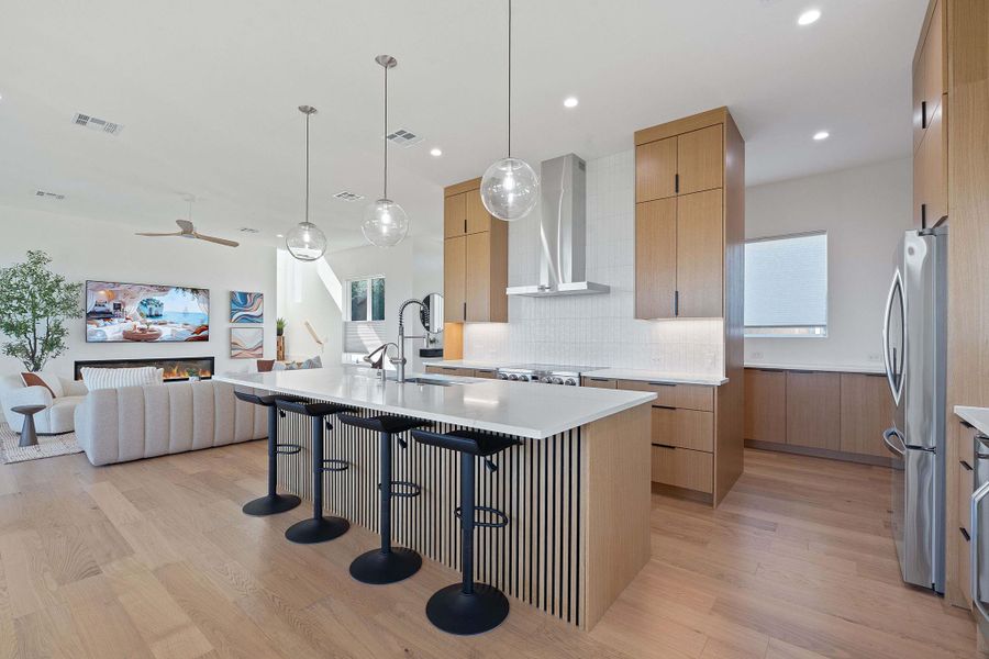 Oversized island, white oak custom cabinetry, and modern pendants, expansive counter space this kitchen was designed to be a cooks pleasure. Oversized island, white oak custom cabinetry, and modern pendants, expansive counter space this kitchen was designed to be a cooks pleasure.