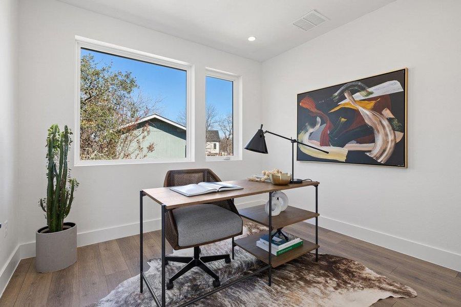 Office area with wood finished floors and recessed lighting