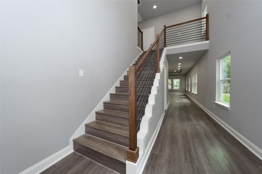 The stunning staircase is a true focal point of the home, featuring elegant steps and a beautifully crafted railing. Its design adds both sophistication and charm, making a striking first impression as it leads you to the upper levels.