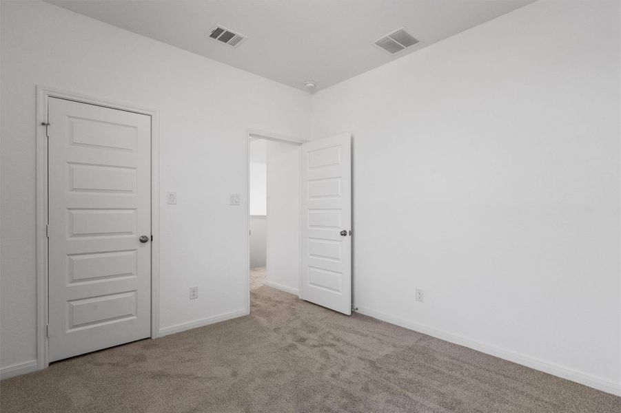 Unfurnished bedroom featuring carpet flooring and baseboards