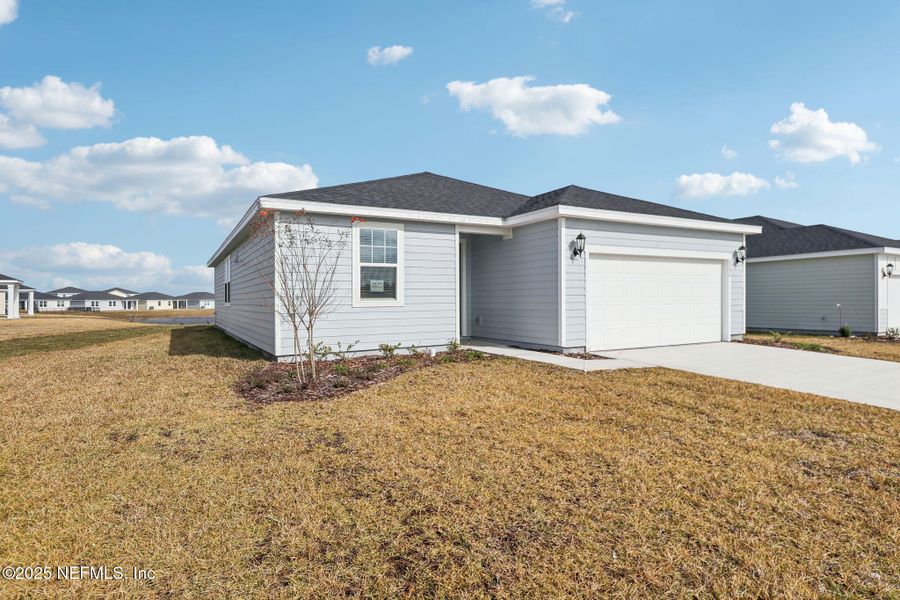Front exterior of a new home in Lakes at Bella Lago - Signature Series, Green Cove Springs, FL, highlighting curb appeal (Image 22).