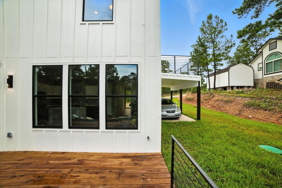 View of property exterior featuring board and batten siding and a lawn View of property exterior featuring board and batten siding and a lawn
