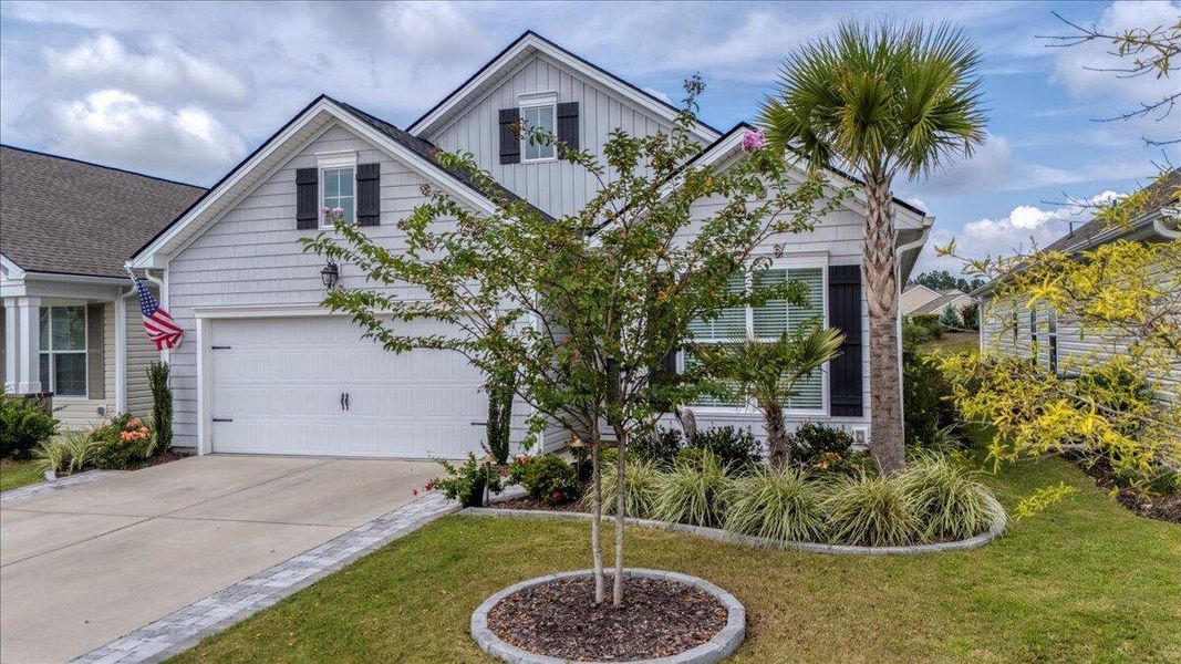 Front exterior of a new home in K. Hovnanian's® Four Seasons at Lakes of Cane Bay, Summerville, SC, highlighting curb appeal (Image 20).