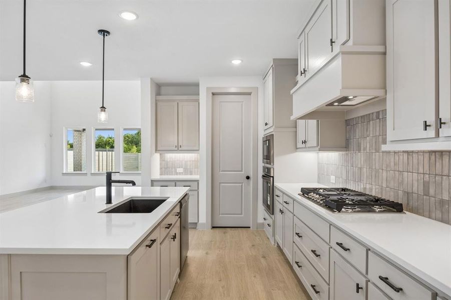 Beautiful cabinetry, gorgeous counter tops and designer backsplash effortlessly pair with contemporary stainless steel and black fixtures to create a kitchen for the ages!