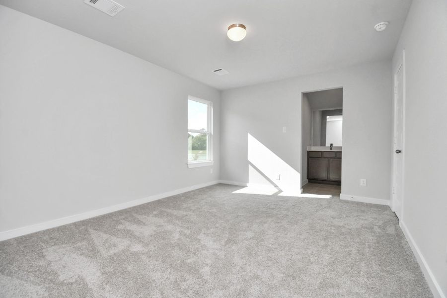 Generously sized secondary bedrooms featuring spacious closets, soft and inviting carpeting underfoot, large windows allowing plenty of natural light, and the added touch of privacy blinds for your personal retreat. Sample photo of completed home with similar floor plan. Actual colors and selections may vary.