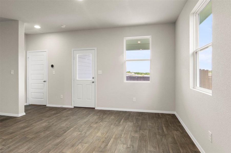 Spare room featuring dark wood-style floors and recessed lighting