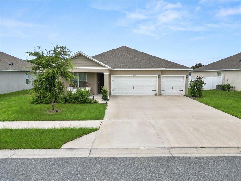 Front exterior of a new home in Wind Meadows South, Bartow, FL, highlighting curb appeal (Image 30). Front exterior of a new home in Wind Meadows South, Bartow, FL, highlighting curb appeal (Image 30).