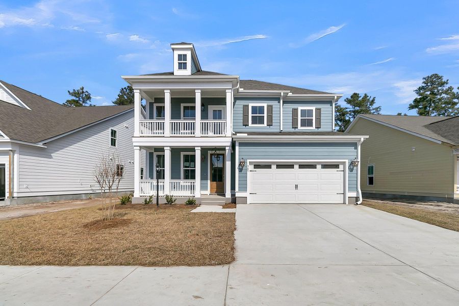 Front exterior of a new home in Tidewater at Lakes of Cane Bay, Summerville, SC, highlighting curb appeal (Image 1).