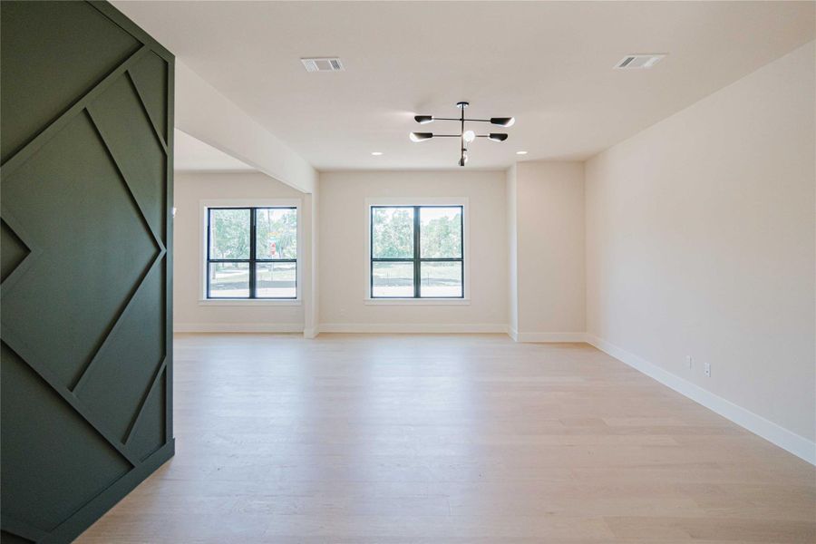Unfurnished room with light wood-style flooring and recessed lighting