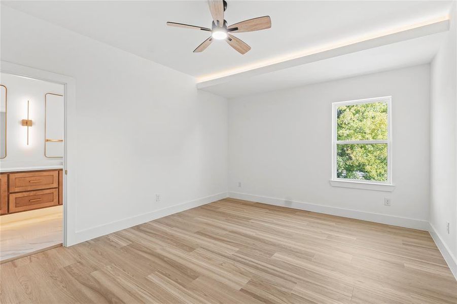 Unfurnished bedroom with light wood finished floors and ceiling fan
