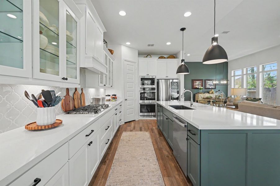 The appliances were an upgrade and include double ovens and microwave, plus a five-burner gas cooktop. The single oversized sink is a granite composite. Recess lighting, under cabinet lighting, and the oversized pendant lights brighten up this work space. The appliances were an upgrade and include double ovens and microwave, plus a five-burner gas cooktop. The single oversized sink is a granite composite. Recess lighting, under cabinet lighting, and the oversized pendant lights brighten up this work space.