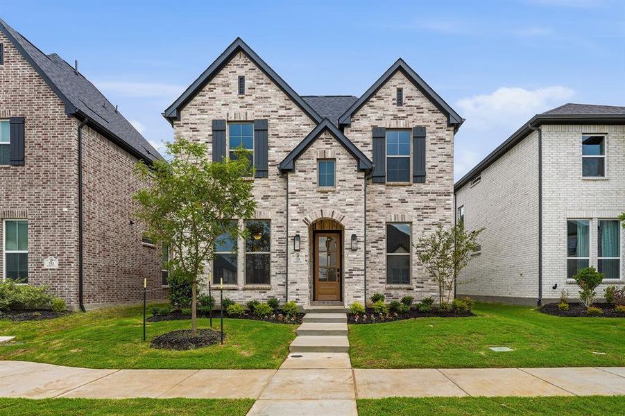Front exterior of a new home in Light Farms Brenham - 40' Lots, Celina, TX, highlighting curb appeal (Image 27). Front exterior of a new home in Light Farms Brenham - 40' Lots, Celina, TX, highlighting curb appeal (Image 27).