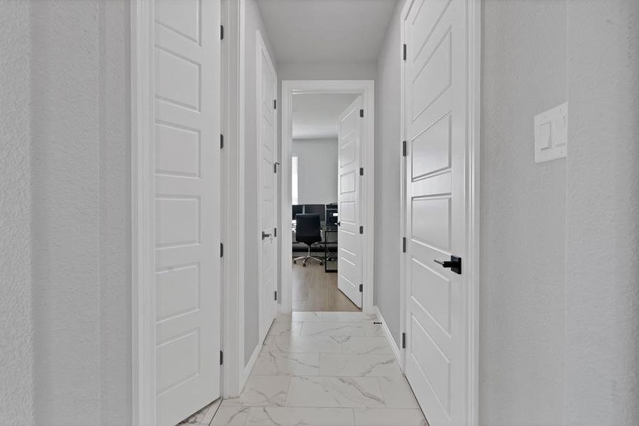 Hall featuring marble finish floor