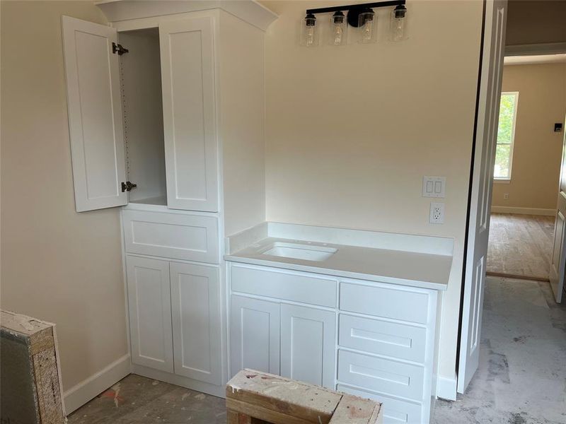 Separate vanities, both with full-size cabinet for linen storage Separate vanities, both with full-size cabinet for linen storage