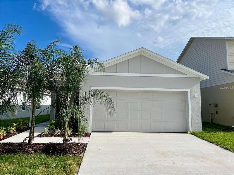 Front exterior of a new home in Hammock Reserve, Haines City, FL, highlighting curb appeal (Image 20). Front exterior of a new home in Hammock Reserve, Haines City, FL, highlighting curb appeal (Image 20).