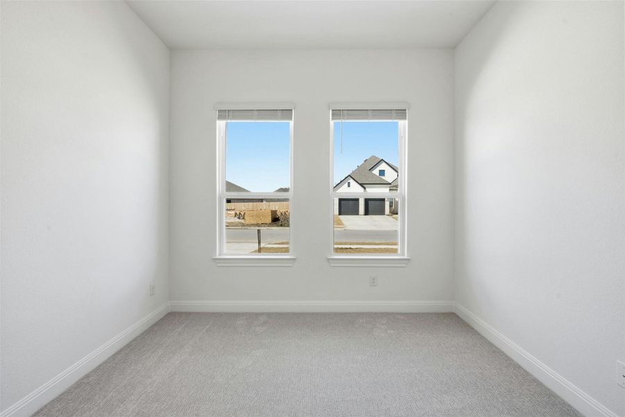 Unfurnished room with light carpet and baseboards