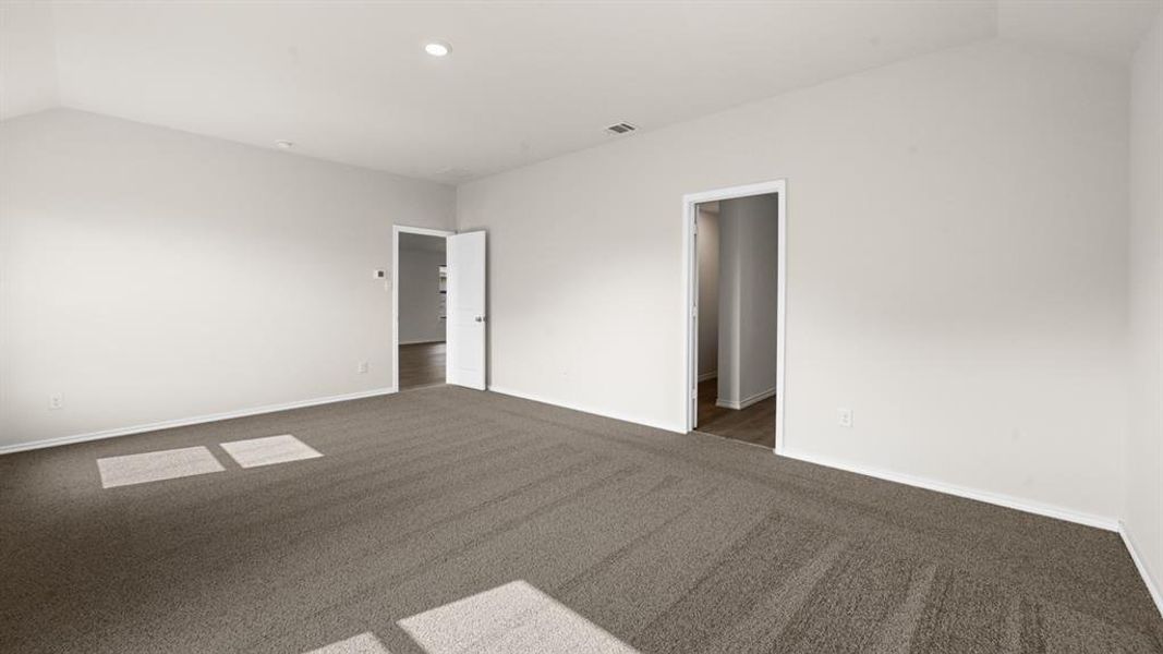 Spacious room featuring neutral carpeting and light-toned walls Spacious room featuring neutral carpeting and light-toned walls