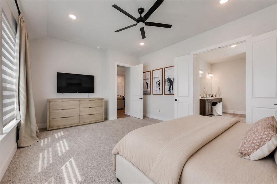 Spacious interior room featuring vaulted ceilings, recessed lighting, and a modern ceiling fan