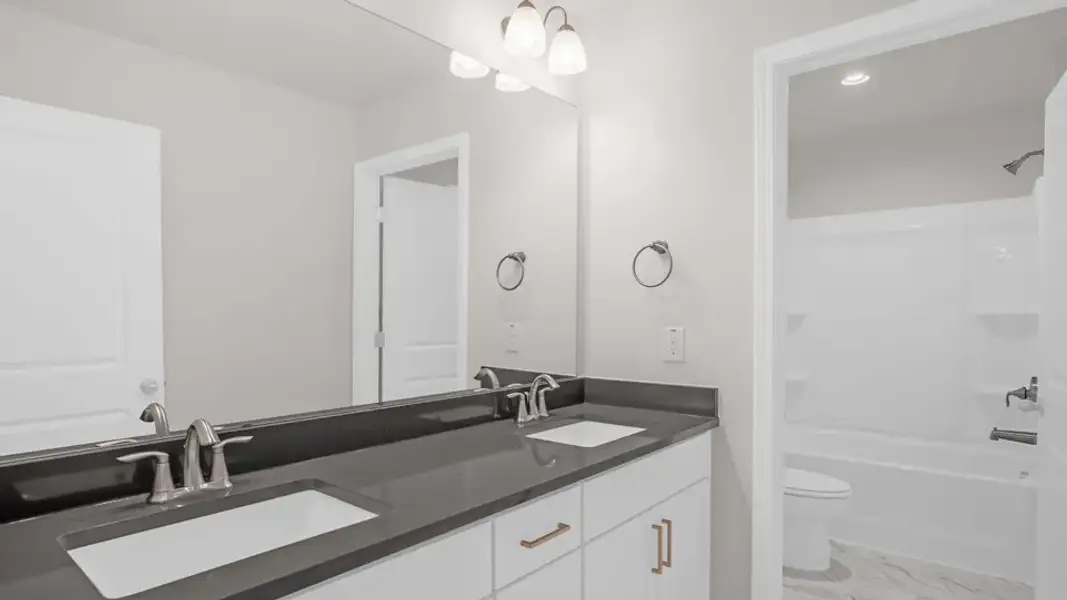 Furnished interior view inside a new home in The Estates Park, Apex (Image 10).