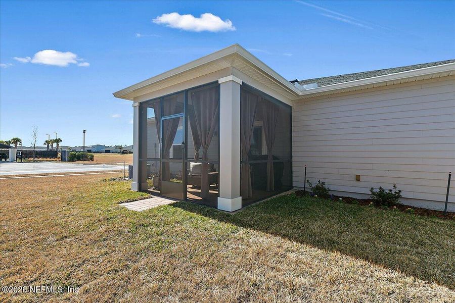 Exterior details and patio area of a home in Edenbrooke at Hyland Trail | 55+, Green Cove Springs (Image 23).