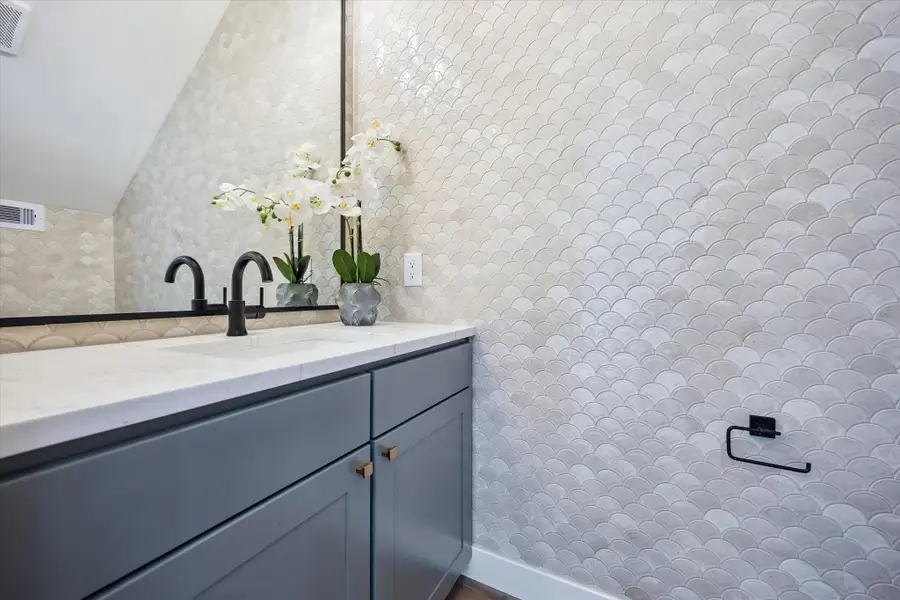 The powder room wall tile is a dream and covers the entire bathroom.