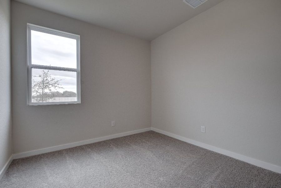 A room with a window and carpet. A room with a window and carpet.