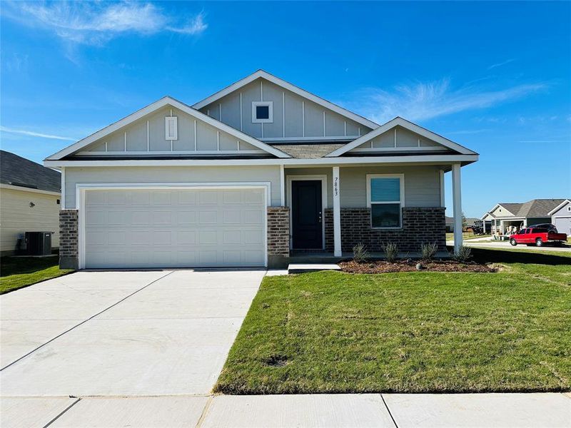 Craftsman house featuring a front yard, a garage, and central air condition unit