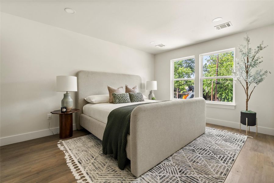 Well-lit sleeping quarters with bright windows and sleek hardwood floors for tranquil nights.