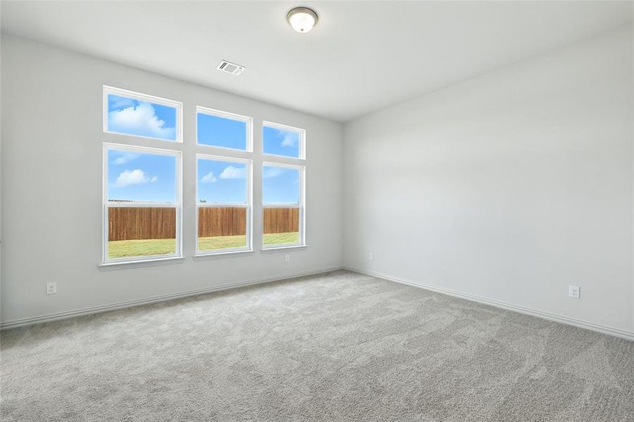 Unfurnished room featuring light colored carpet and baseboards Unfurnished room featuring light colored carpet and baseboards