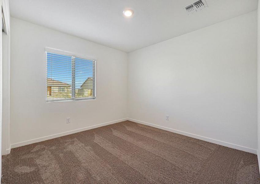 Windows let in plenty of light to this secondary bedroom.