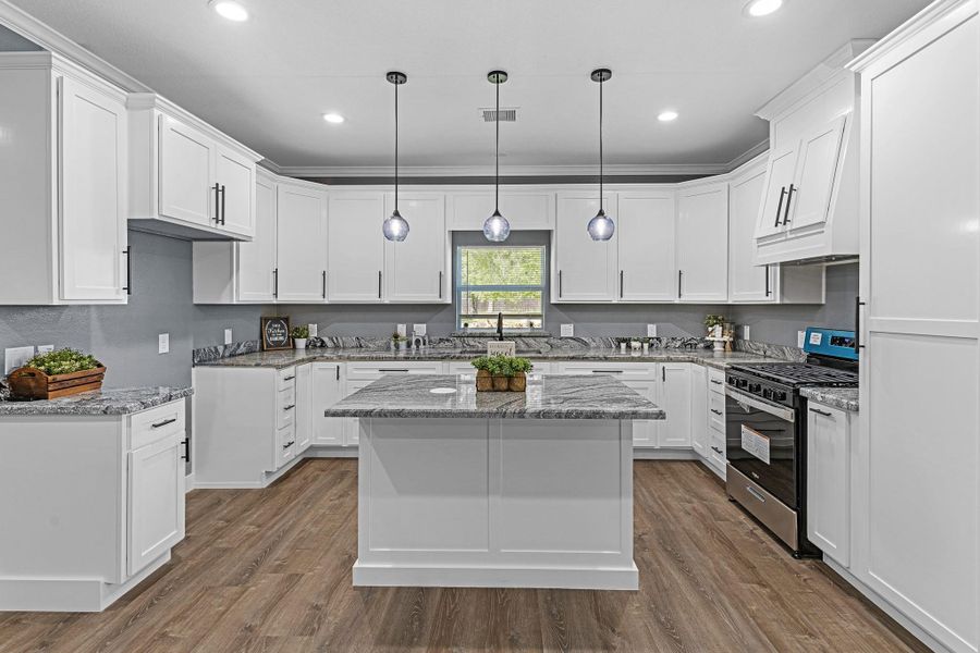 Modern light fixtures, granite countertops, white-crisp cabinets with modern fixtures. The Farmhouse Kitchen you have been looking for!
