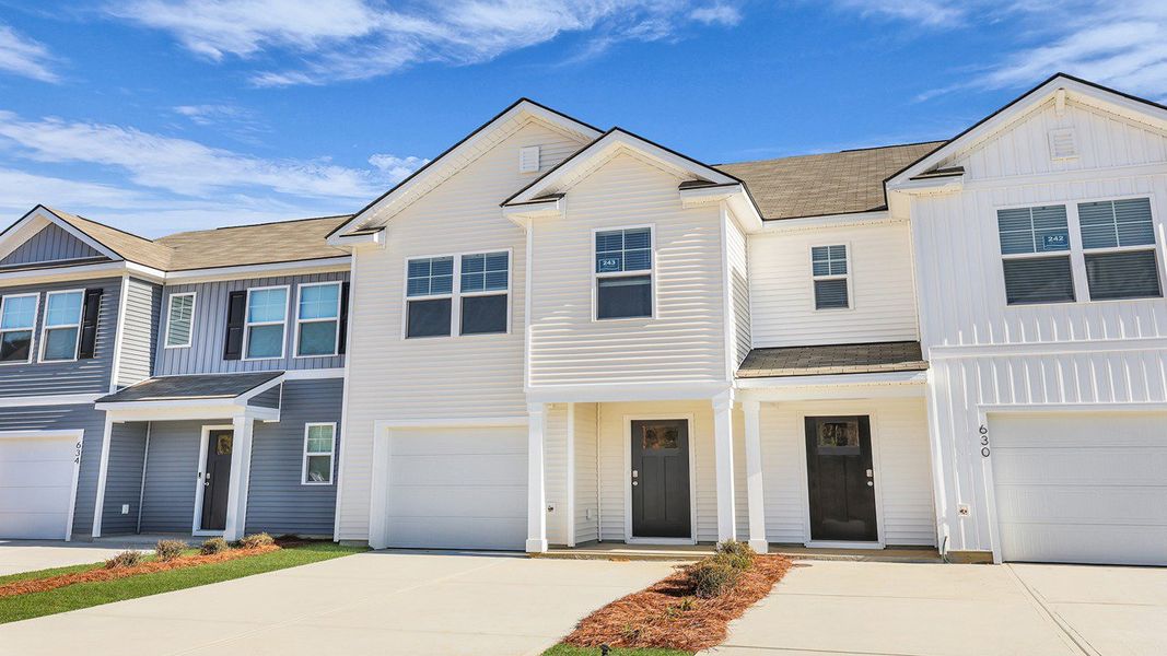 Front exterior of a new home in Pine Hills Townhomes at Cane Bay, Summerville, SC, highlighting curb appeal (Image 21). Front exterior of a new home in Pine Hills Townhomes at Cane Bay, Summerville, SC, highlighting curb appeal (Image 21).