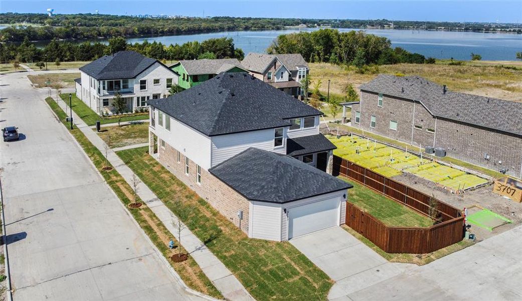 Birds eye view of property with a water view