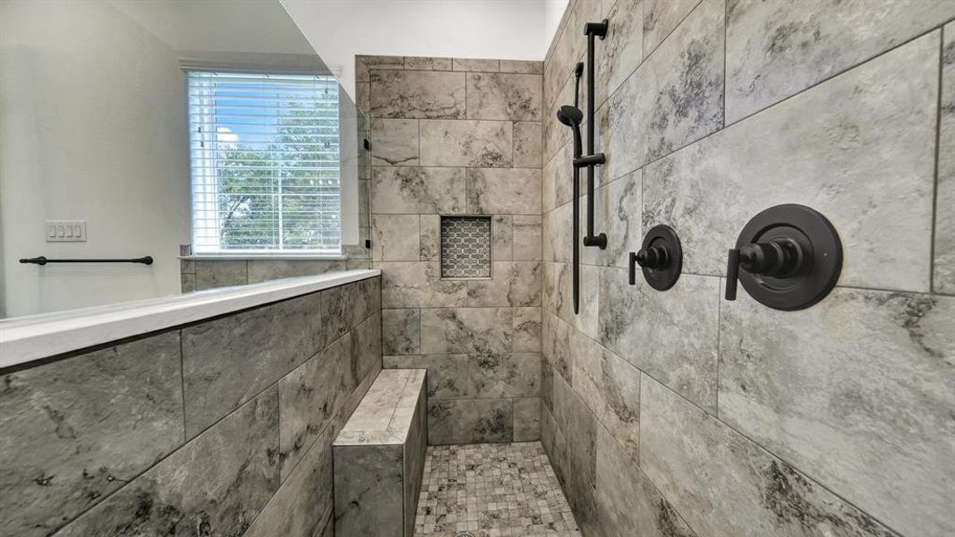 Bathroom featuring tiled shower