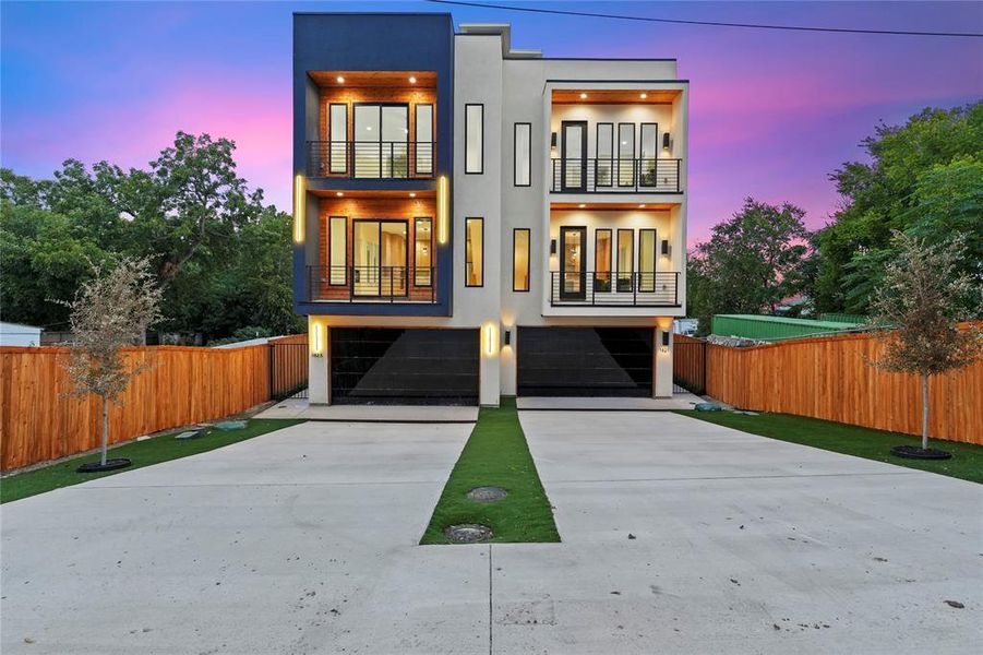 Contemporary house with stucco siding, driveway, a garage, and a balcony Contemporary house with stucco siding, driveway, a garage, and a balcony