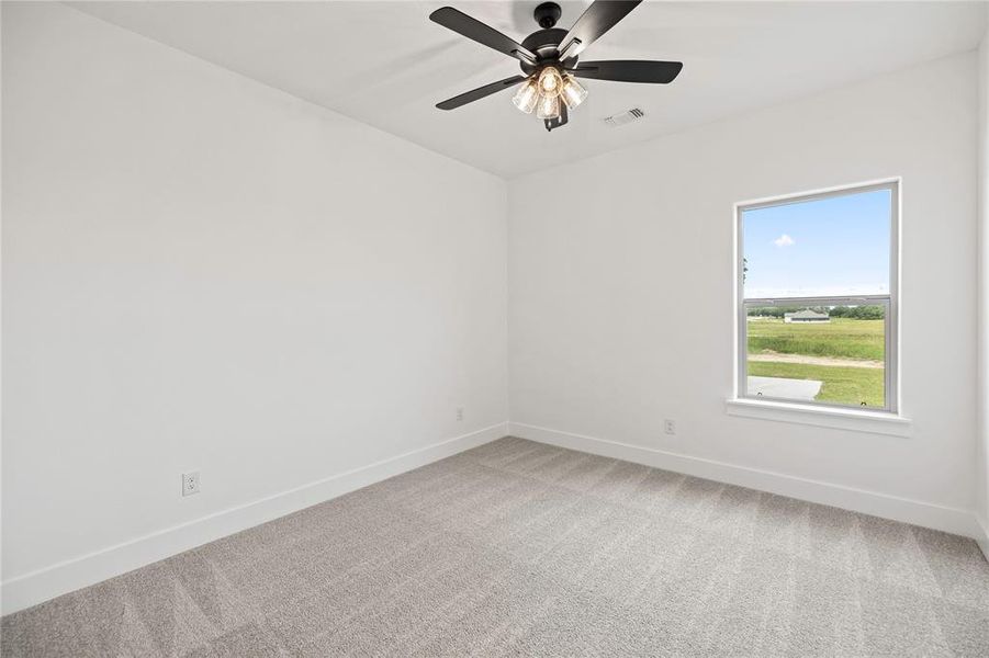 Unfurnished room with carpet and ceiling fan Unfurnished room with carpet and ceiling fan