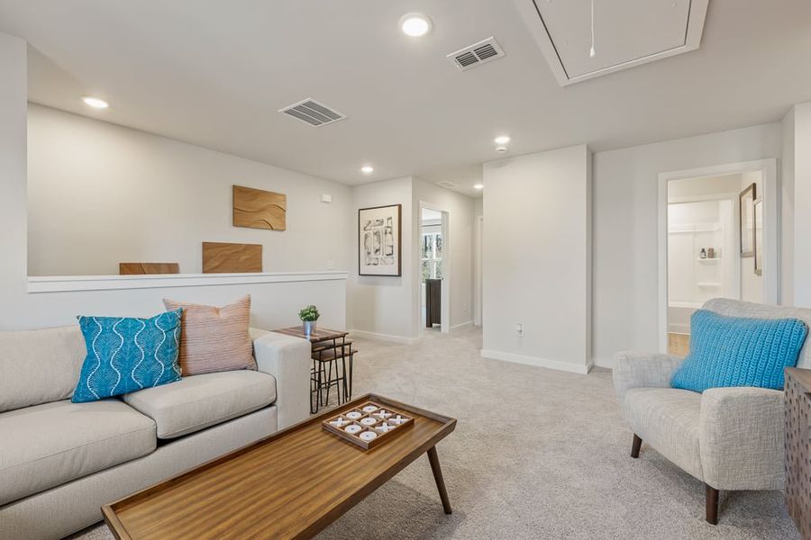 A living room with a couch and a coffee table. A living room with a couch and a coffee table.