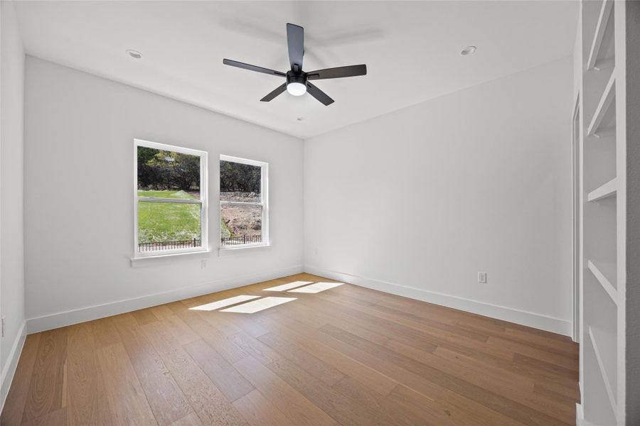 Unfurnished room with light wood-style flooring and ceiling fan Unfurnished room with light wood-style flooring and ceiling fan