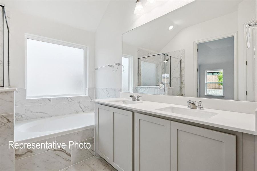 Double vanity with undermount sinks, quartz countertops, and a full-width mirror