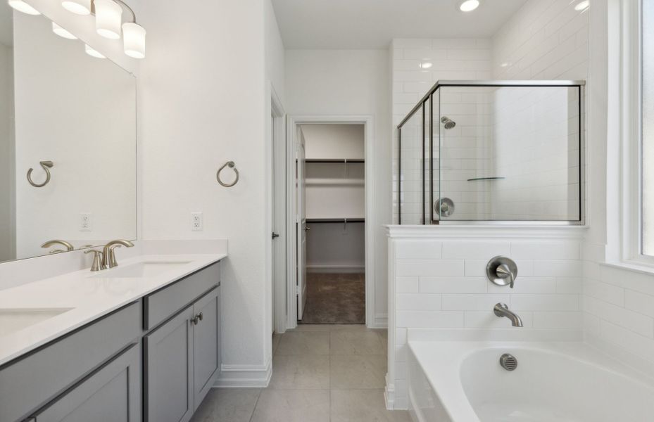 Elegant owner's bathroom with dual vanity and oversized shower