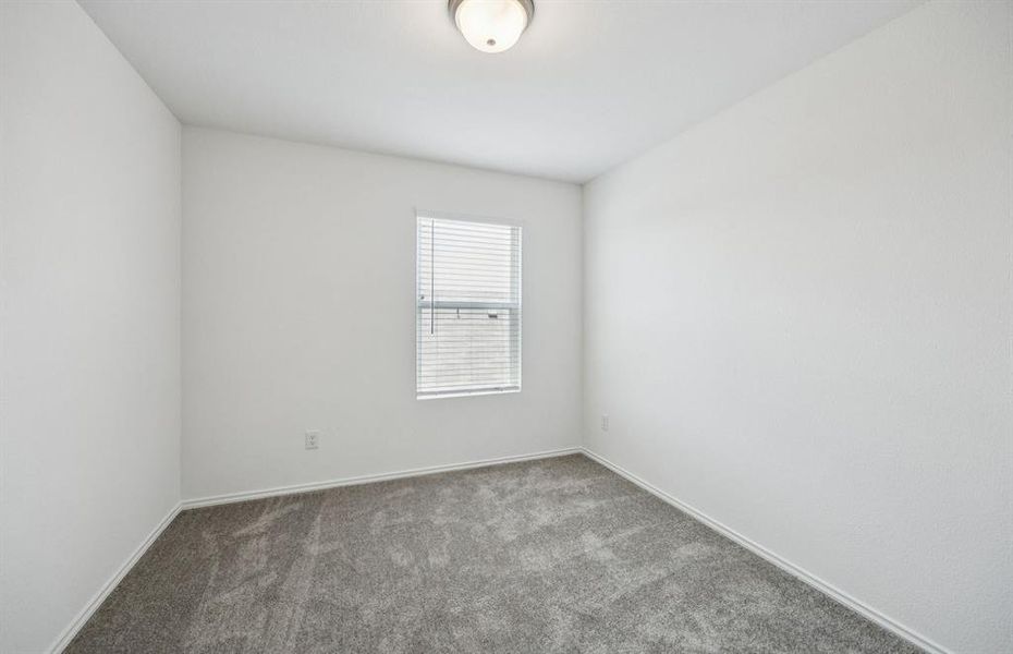 Spacious secondary bedroom with large windows