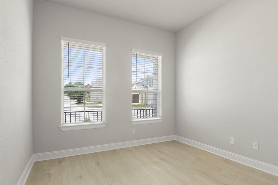Unfurnished room featuring light wood-style floors and plenty of natural light