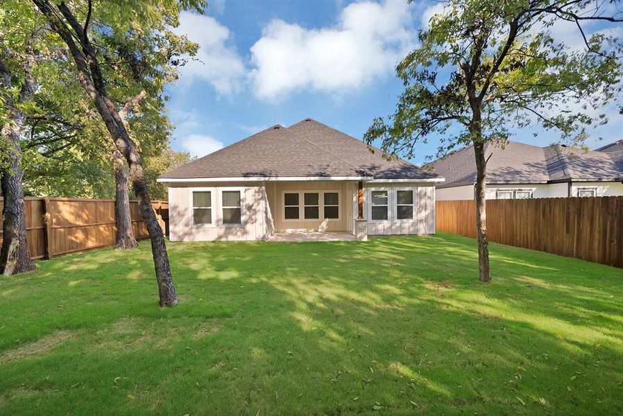 Back of property with a patio area, a shingled roof, and a fenced backyard