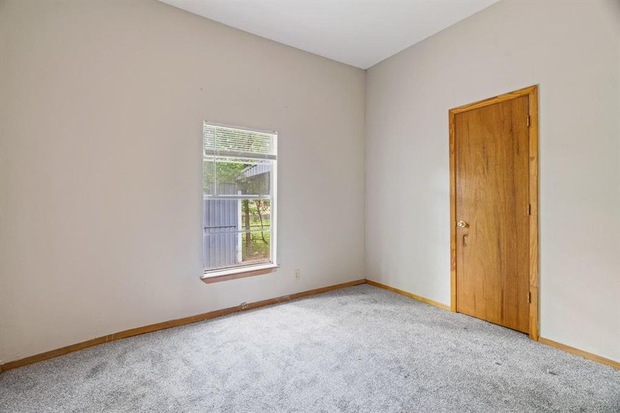Carpeted empty room with baseboards Carpeted empty room with baseboards