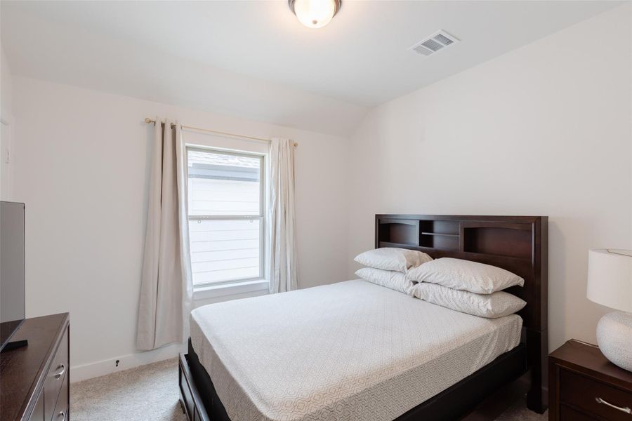 2nd bedroom upstairs with carpeted floor
